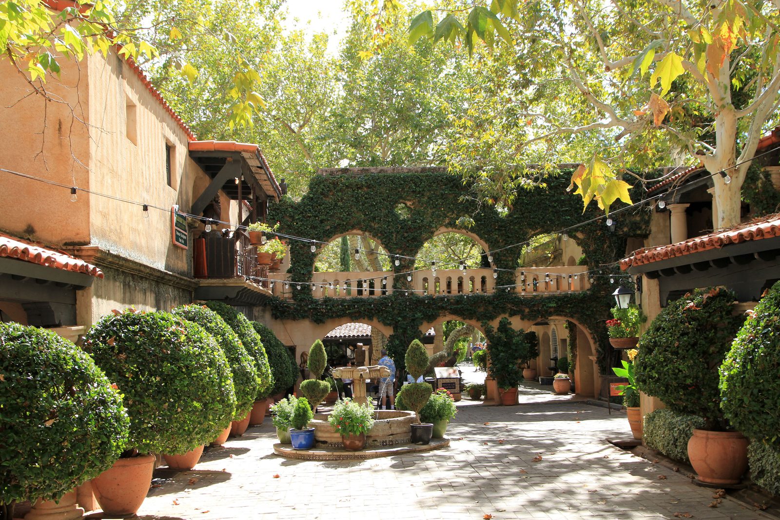 Tlaquepaque-style courtyard with archways, fountains and potted plants