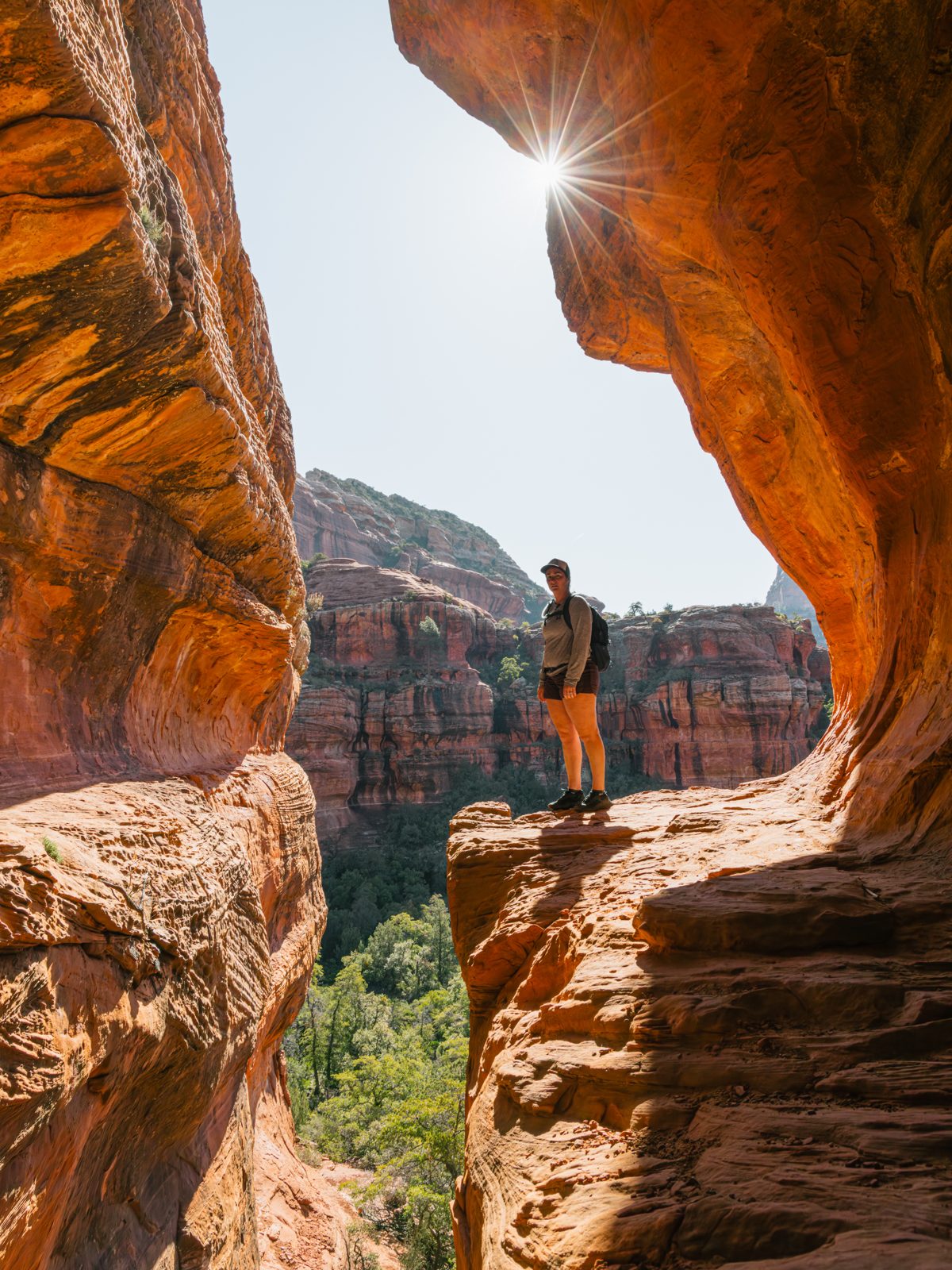 Solo hiker framed by a Sedona arch