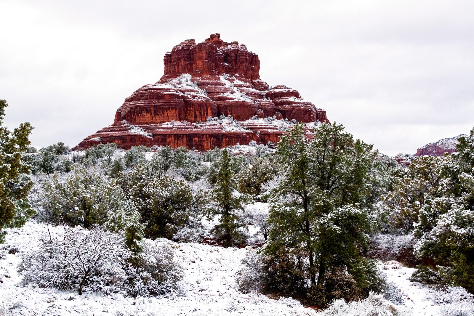 Bell Rock dusted with rare Sedona snow against a blue sky