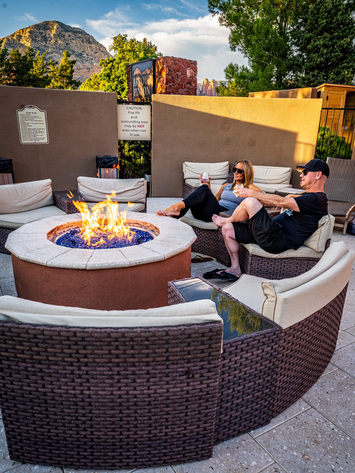 Guests gathered around a sunset firepit at Arroyo Pinion