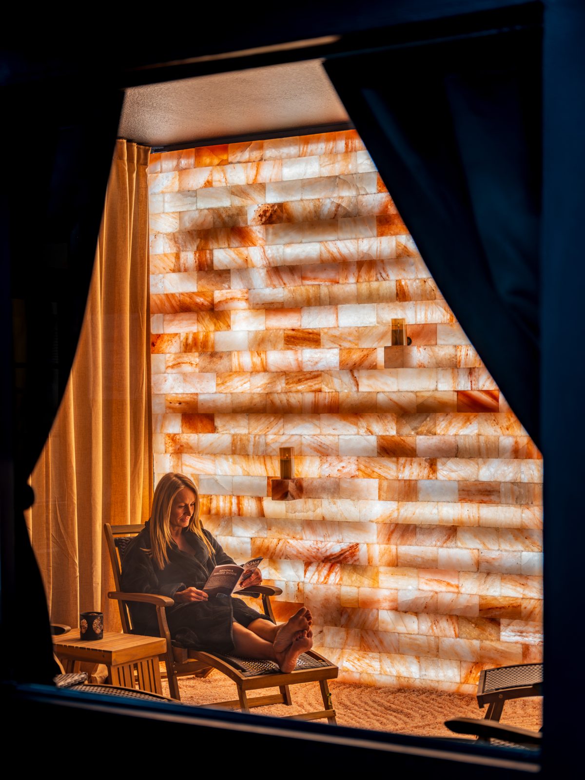 Guest reading by lamplight inside the Himalayan salt cave at Arroyo Pinion